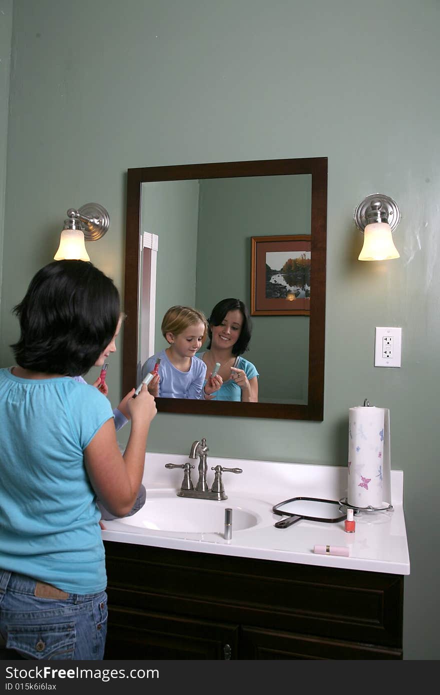 Big and little girls playing with makeup