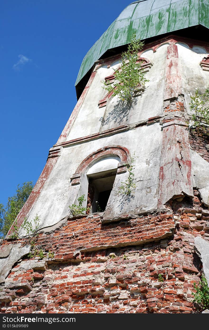 The ruined mill. Old brick wall with visible damage, erosion - different colour bricks