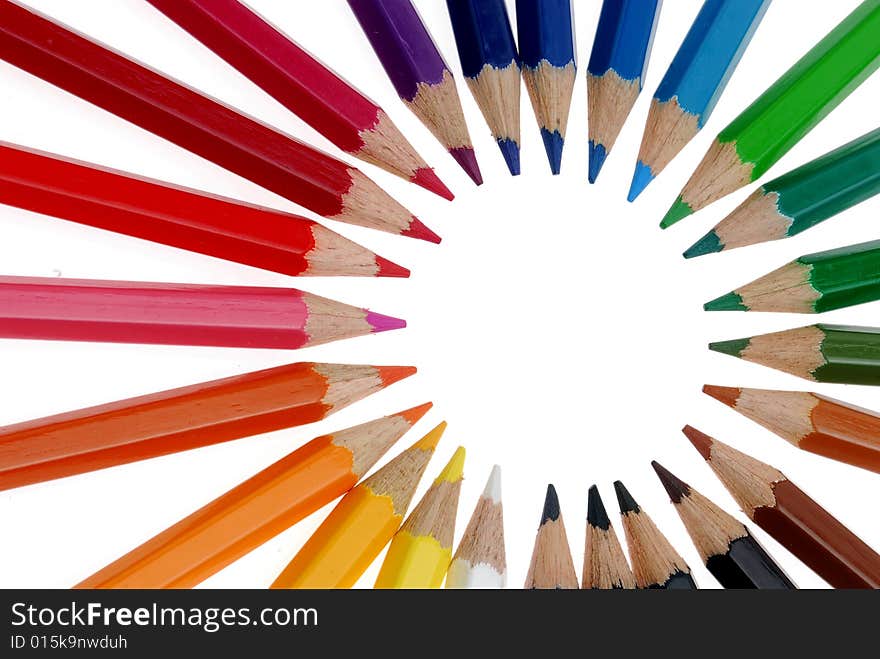 Wooden pens align a circle on white background