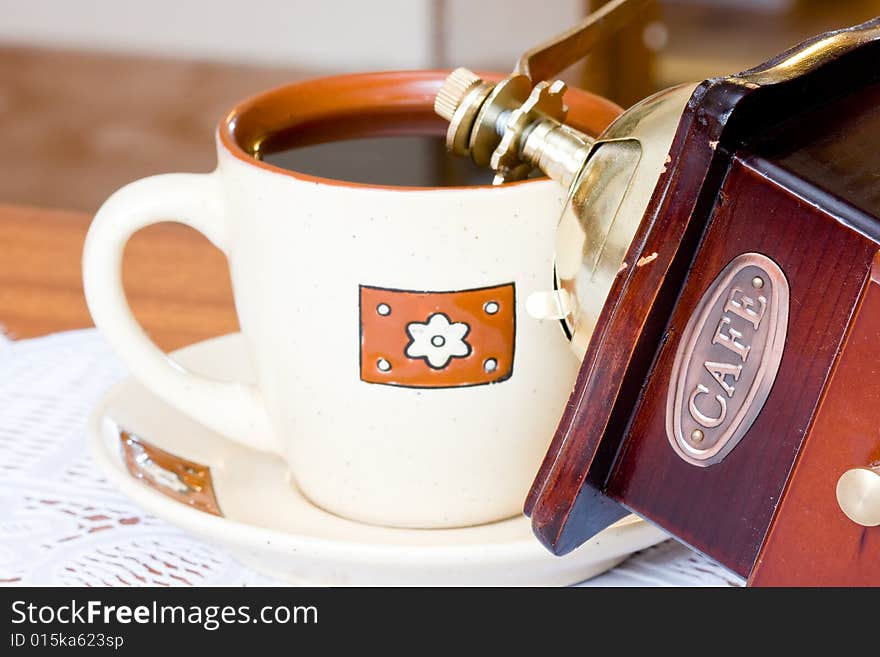 A coffee-mill on a table. A coffee-mill on a table