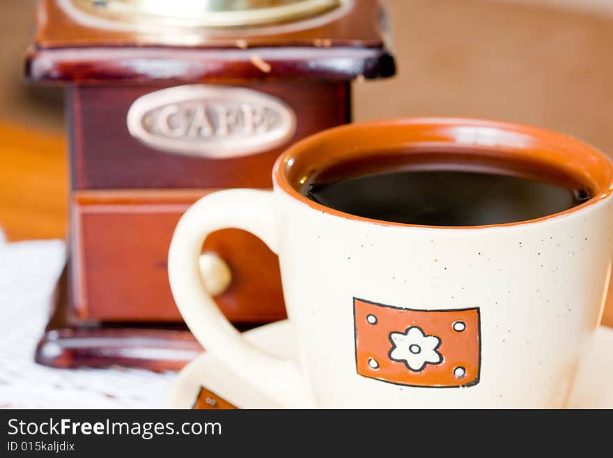 A coffee-mill on a table. A coffee-mill on a table