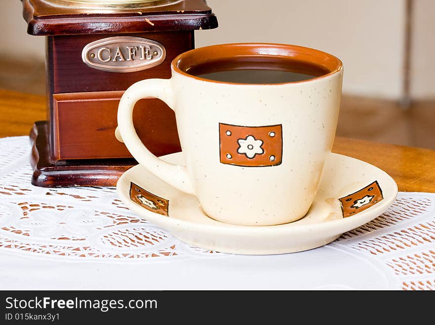 A coffee-mill on a table. A coffee-mill on a table