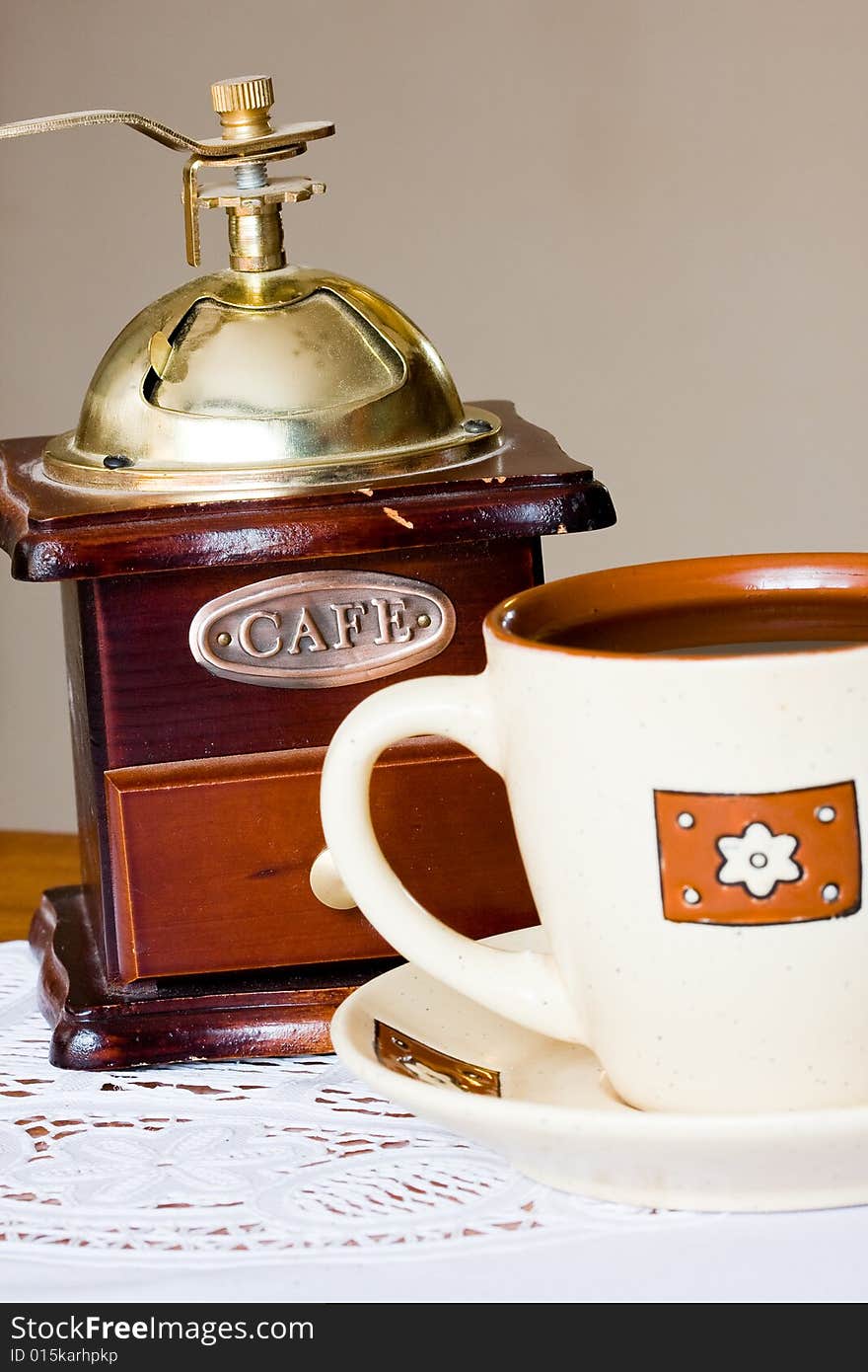 A coffee-mill on a table. A coffee-mill on a table