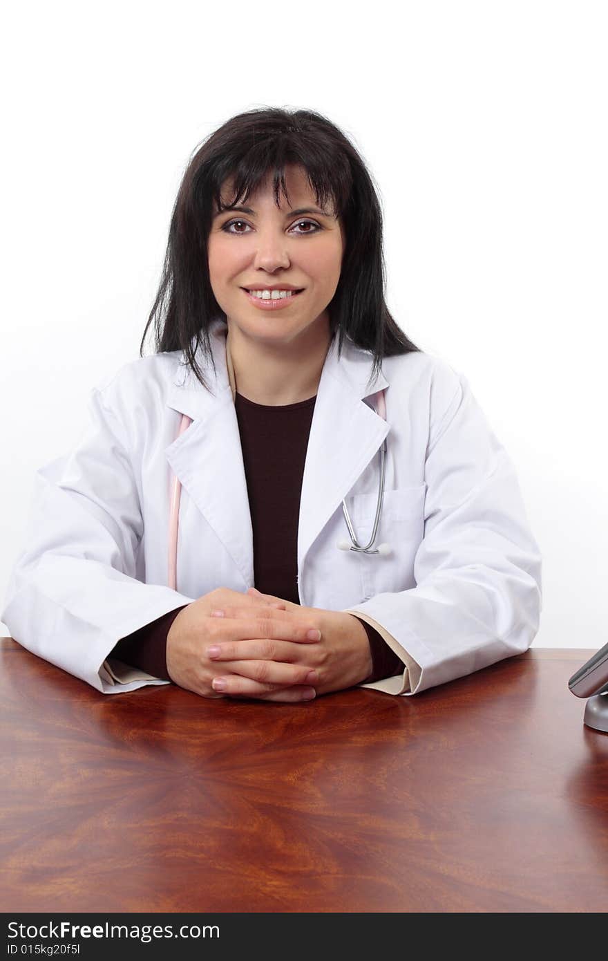 Smiling Doctor Sitting At Desk