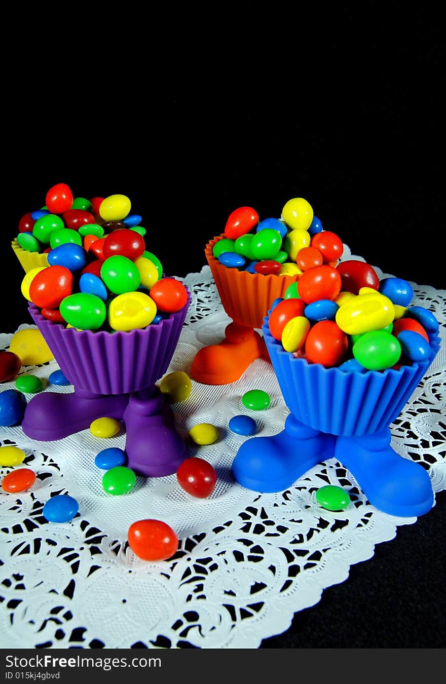 Bright party cups filled with colorful candy. Bright party cups filled with colorful candy.