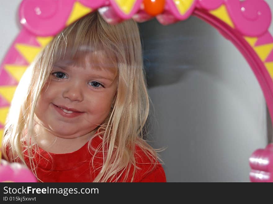 Little girl's reflection in the mirror. Little girl's reflection in the mirror.