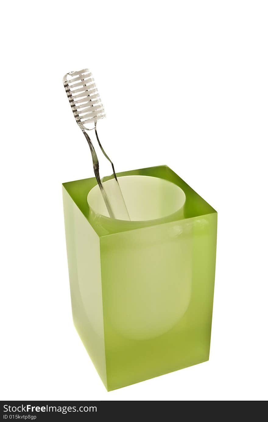 Toothbrushes in glass on a white background