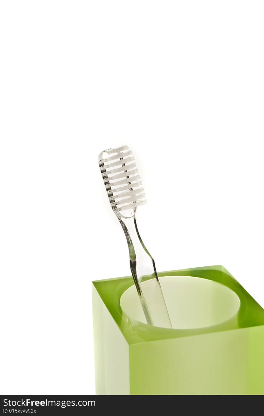 Toothbrushes in glass on a white background