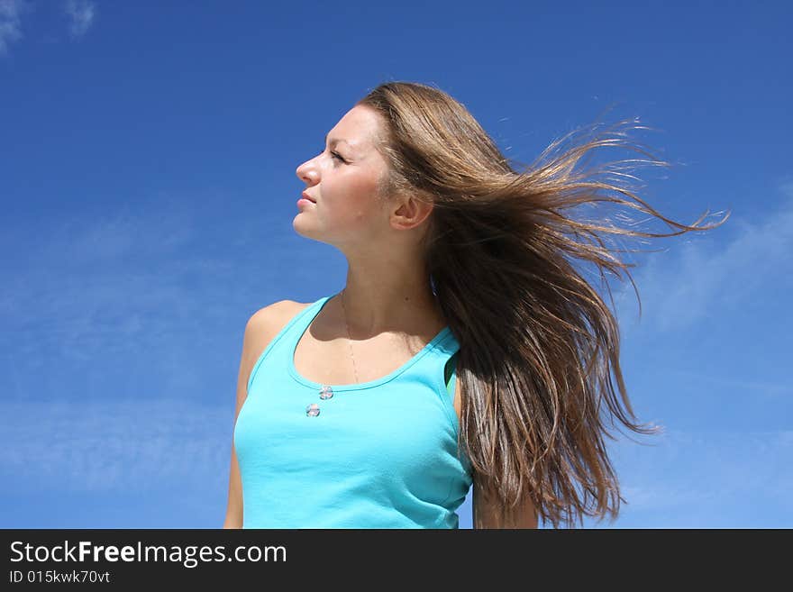 The young girl on a background of the dark blue sk