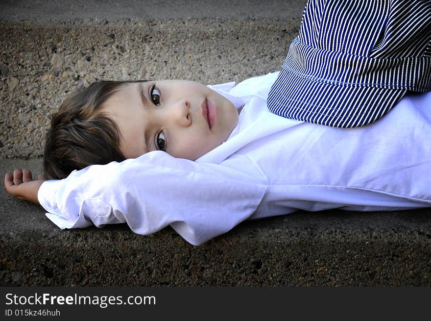 Small child looking into the camera laying down. Small child looking into the camera laying down