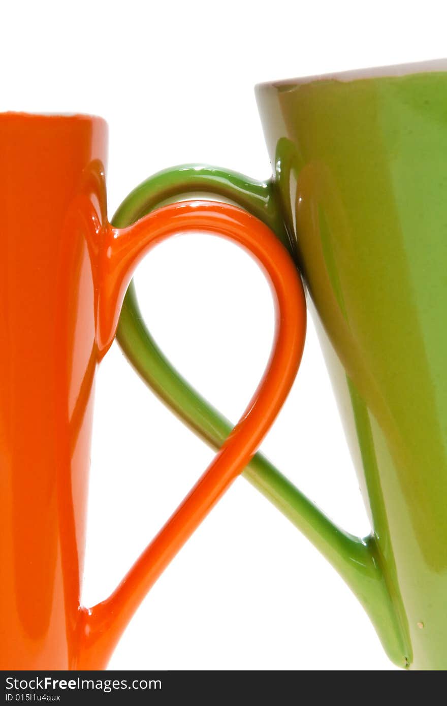 Orange and green tea cup handles, isolated