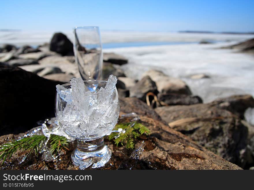 Glasses with ice on the edge of a frozen lake