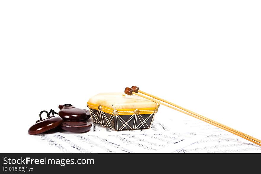 Traditional brazilian drum and printed music isolated on the white background. Traditional brazilian drum and printed music isolated on the white background