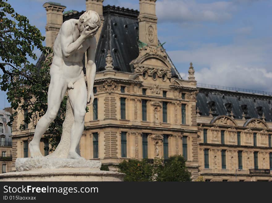 Crying statue at Louvre Museum on summer day in Paris, France.