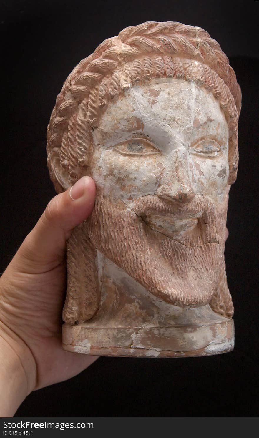 Ancient Greek Statue Of A God In Hand Isolated