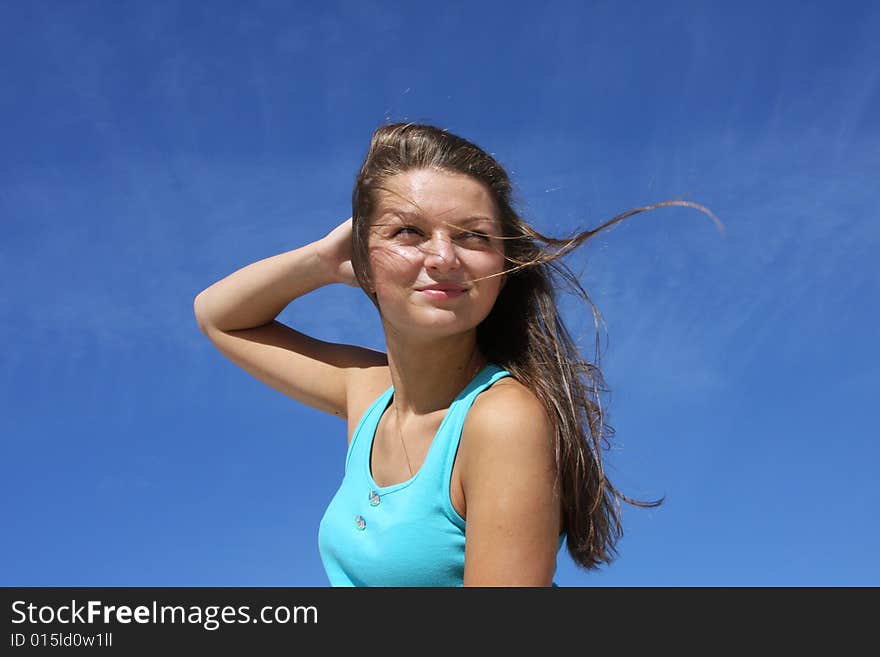 The young girl on a background of the dark blue sk