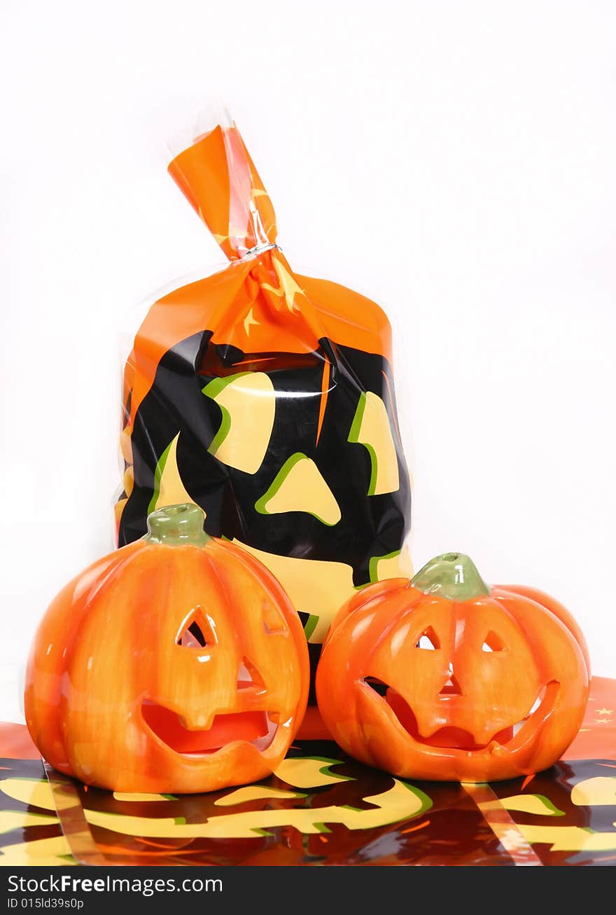 Halloween treat bag with two ceramic pumpkins on an isolated white background. Halloween treat bag with two ceramic pumpkins on an isolated white background