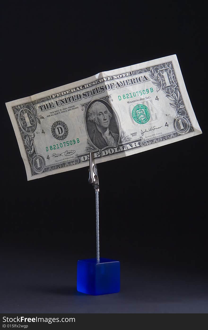 American banknote on a clothespin on a black background. American banknote on a clothespin on a black background