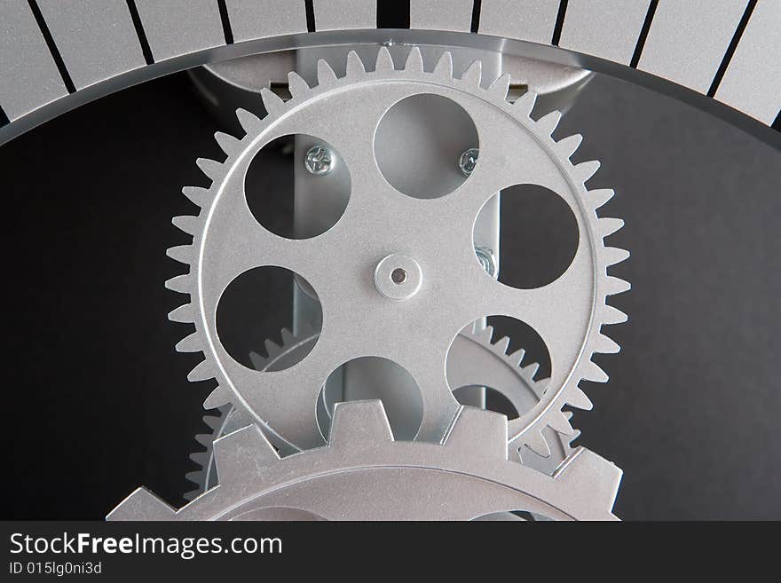 Mechanism with metal gears on a grey background