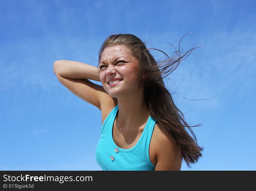 The young girl on a background of the dark blue sk