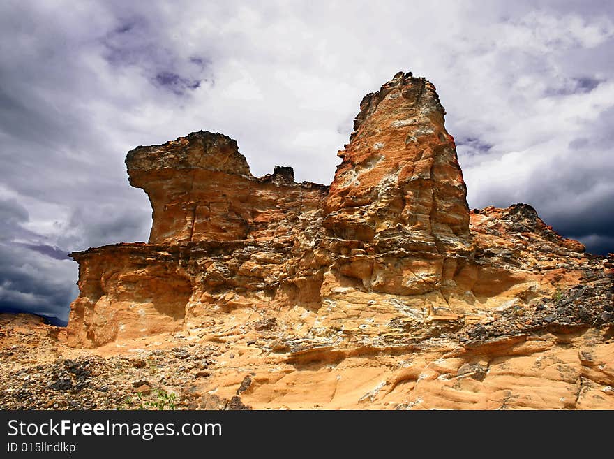 Cliff with storm cloud background.