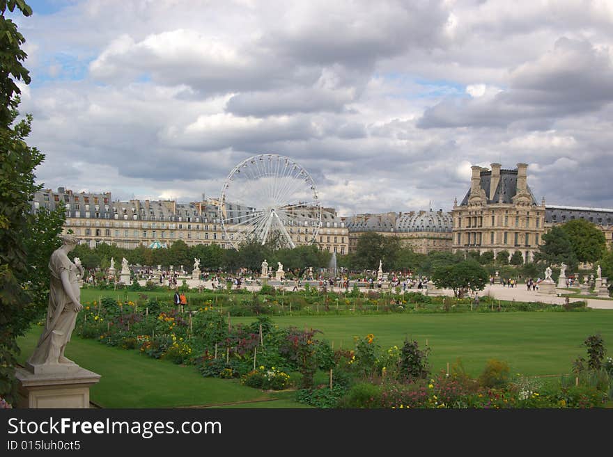 Garden and buildings in Paris, under cloudy sky. Garden and buildings in Paris, under cloudy sky.