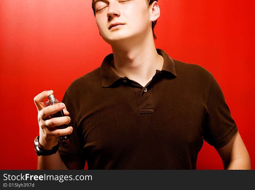 Young pensive man over red background