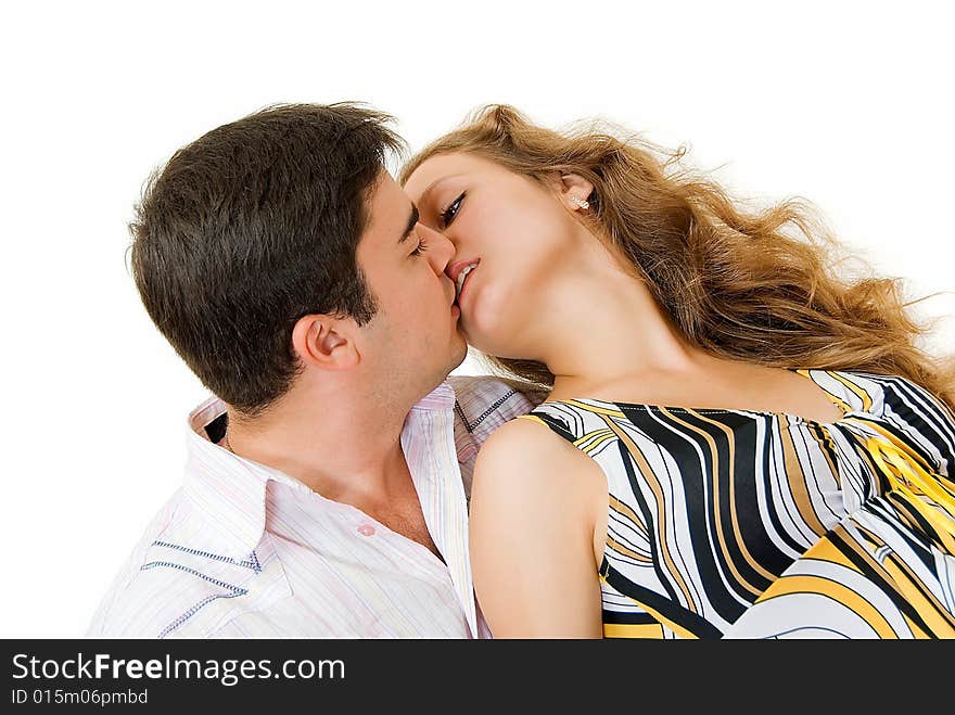 Kissing young couple with open eyes on white background. Kissing young couple with open eyes on white background