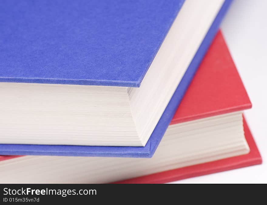 Stacked books on white background