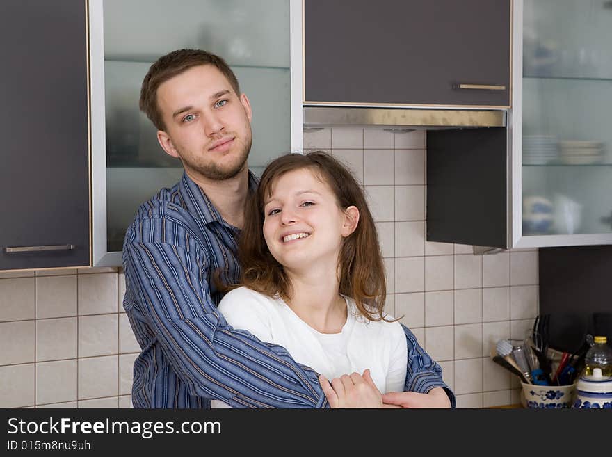 Happy couple together in kitchen