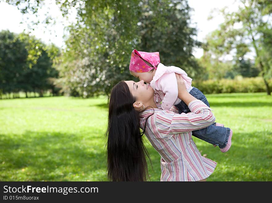 Happy family playing in park. Happy family playing in park