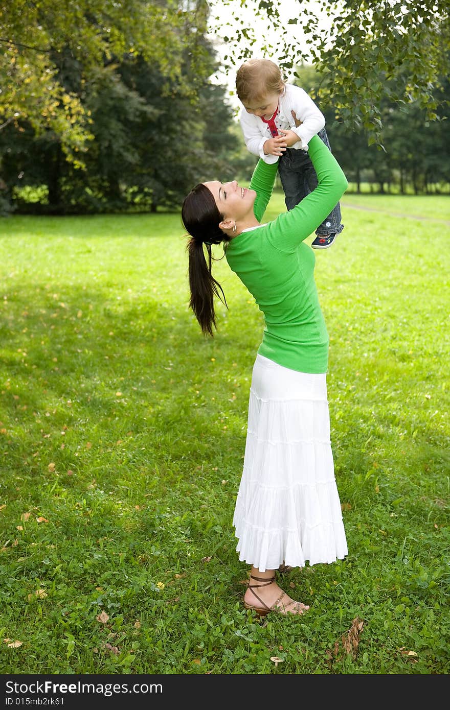 Happy family playing in park. Happy family playing in park