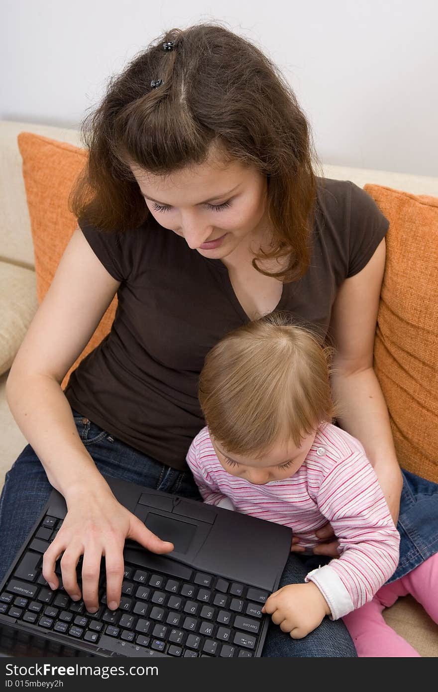 Happy family sitting on sofa with laptop. Happy family sitting on sofa with laptop