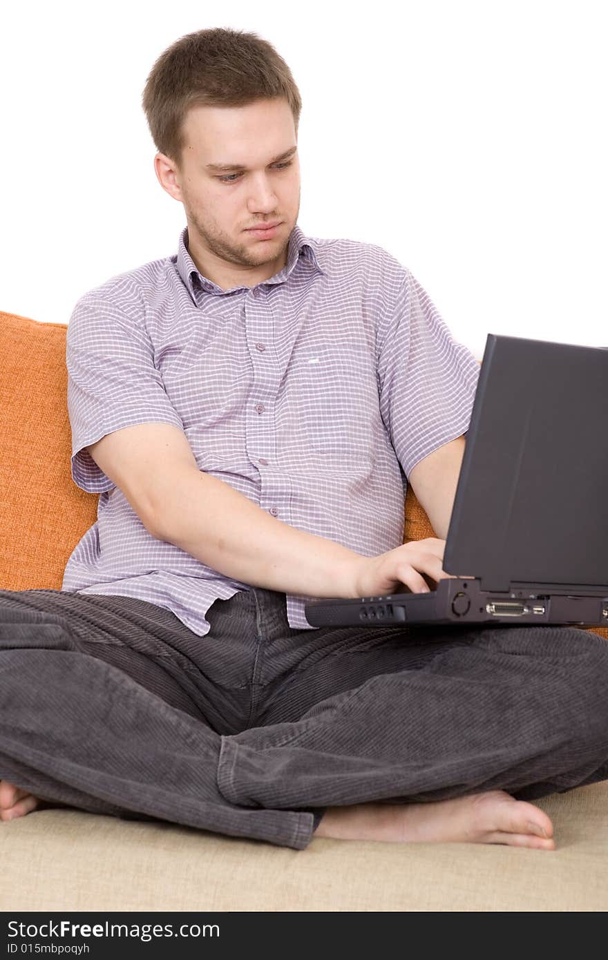 Casual guy sitting on sofa with laptop. Casual guy sitting on sofa with laptop