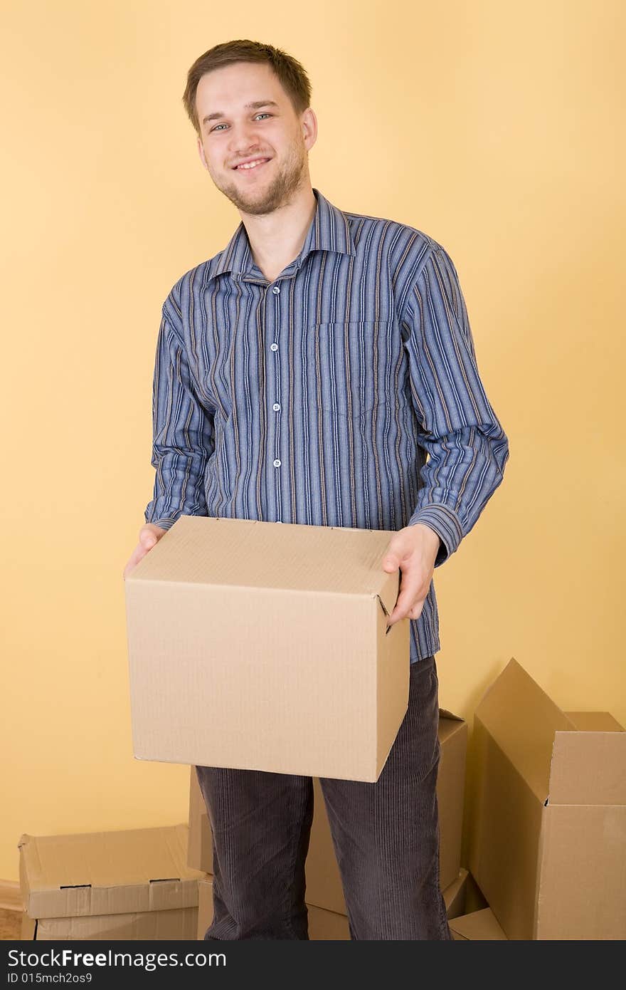 Happy man with boxes moving in