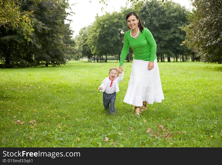 Happy family playing in park. Happy family playing in park