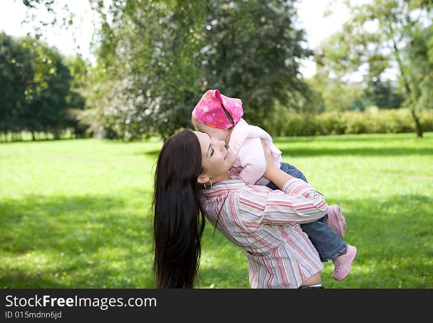 Happy family playing in park. Happy family playing in park