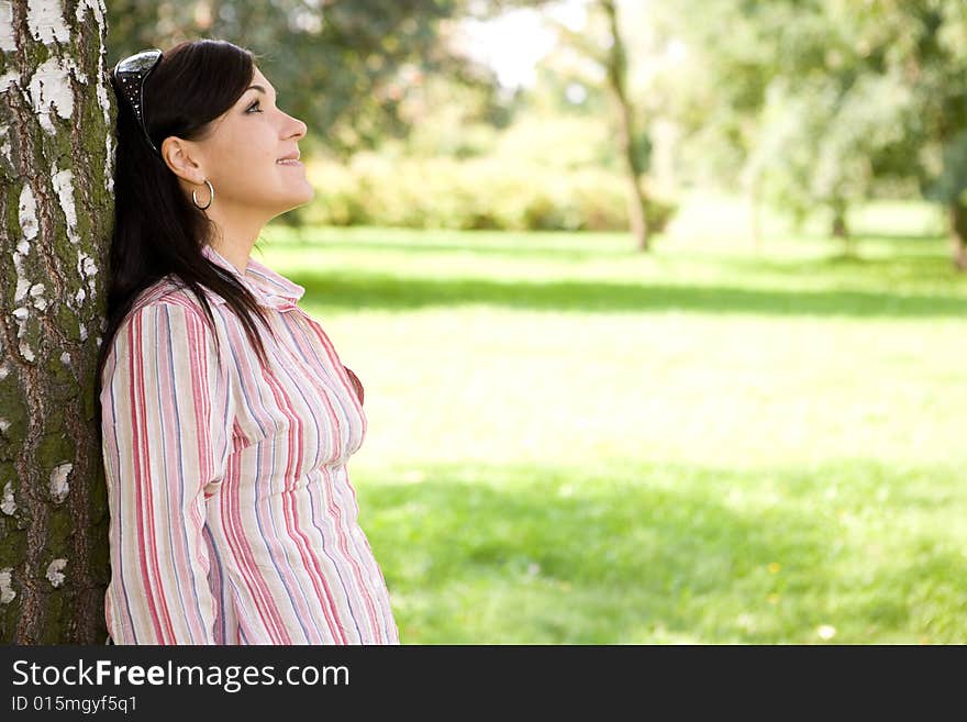 Attractive brunette woman in park. Attractive brunette woman in park