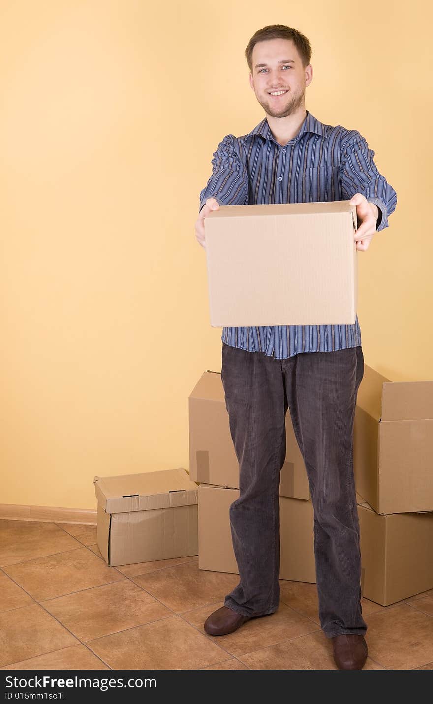 Happy man with boxes moving in