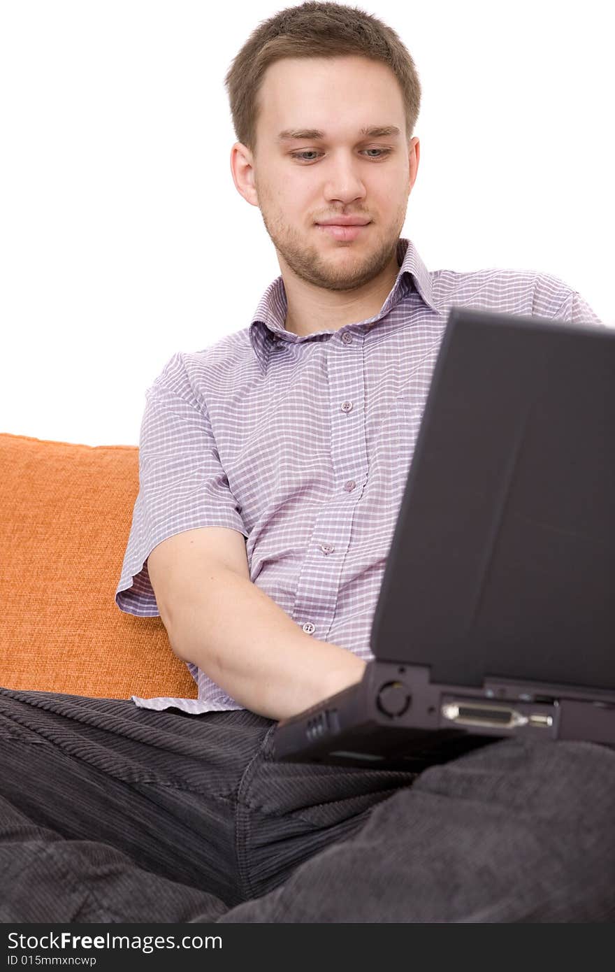 Casual guy sitting on sofa with laptop. Casual guy sitting on sofa with laptop