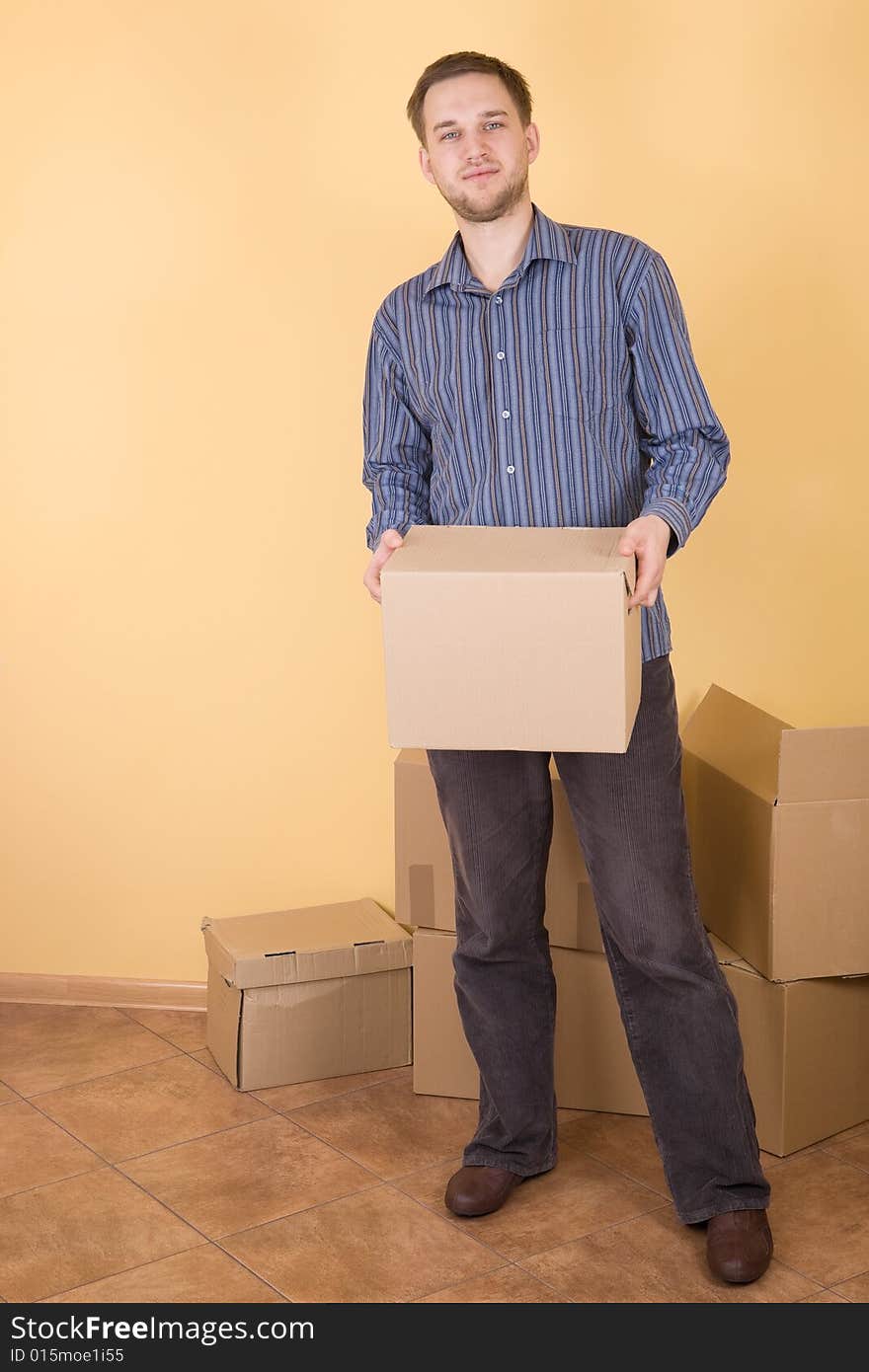 Happy man with boxes moving in