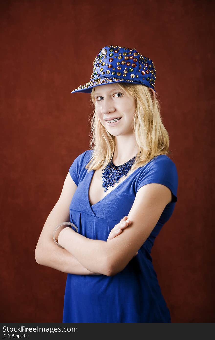 Teenage girl with braces wearing a hat with sequins. Teenage girl with braces wearing a hat with sequins