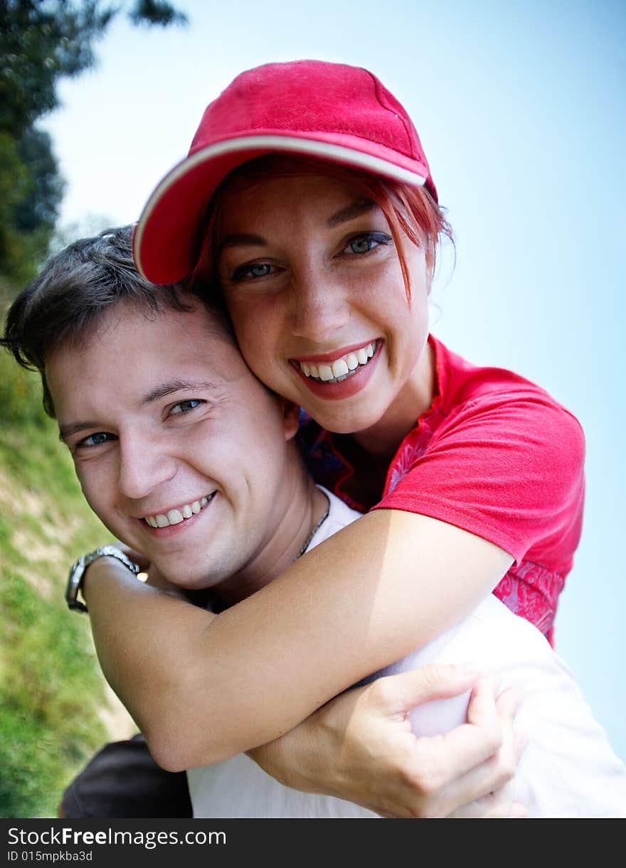 Young happy coupleon vacation, piggyback