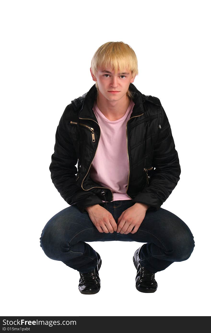 Young man in jacket sits. Isolated