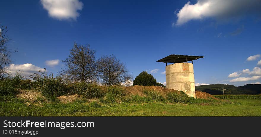 A granary with a blue sky and green grass