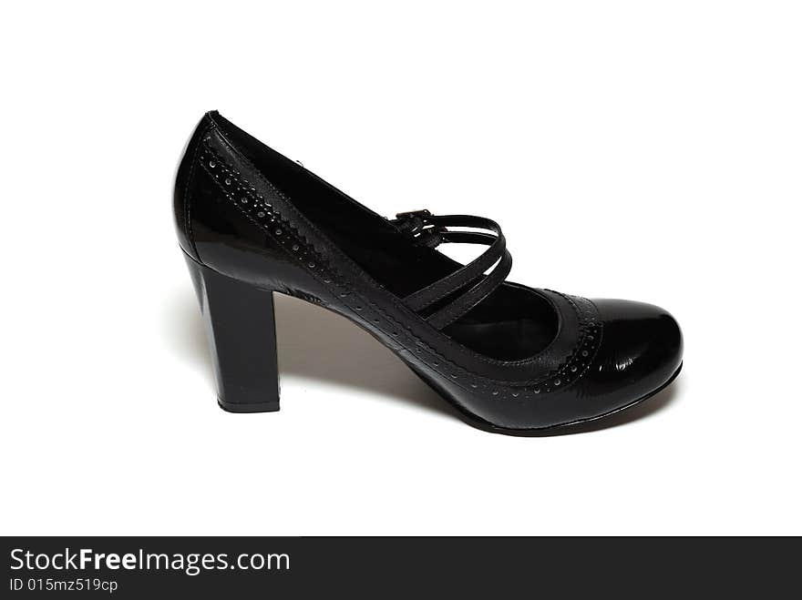 A picture of one high heel black shoe