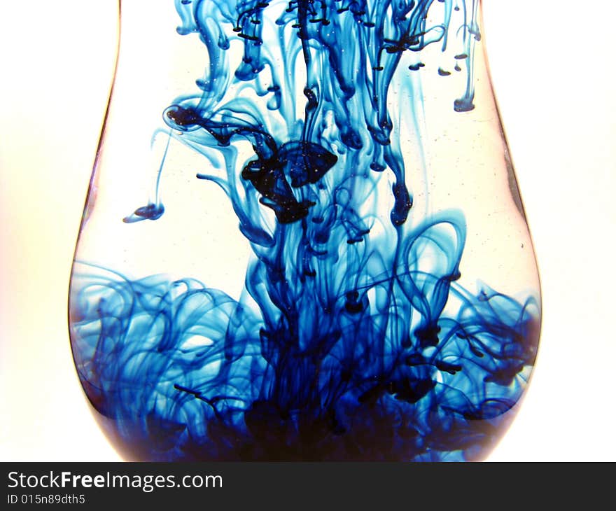 An abstract shot of swirls of blue within clear liquid. An abstract shot of swirls of blue within clear liquid