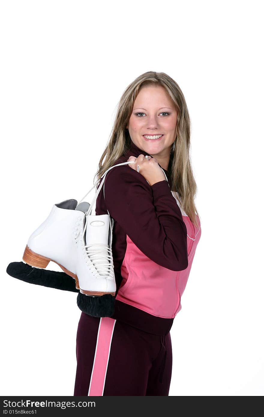 Happy young woman holding figure skates over her shoulder