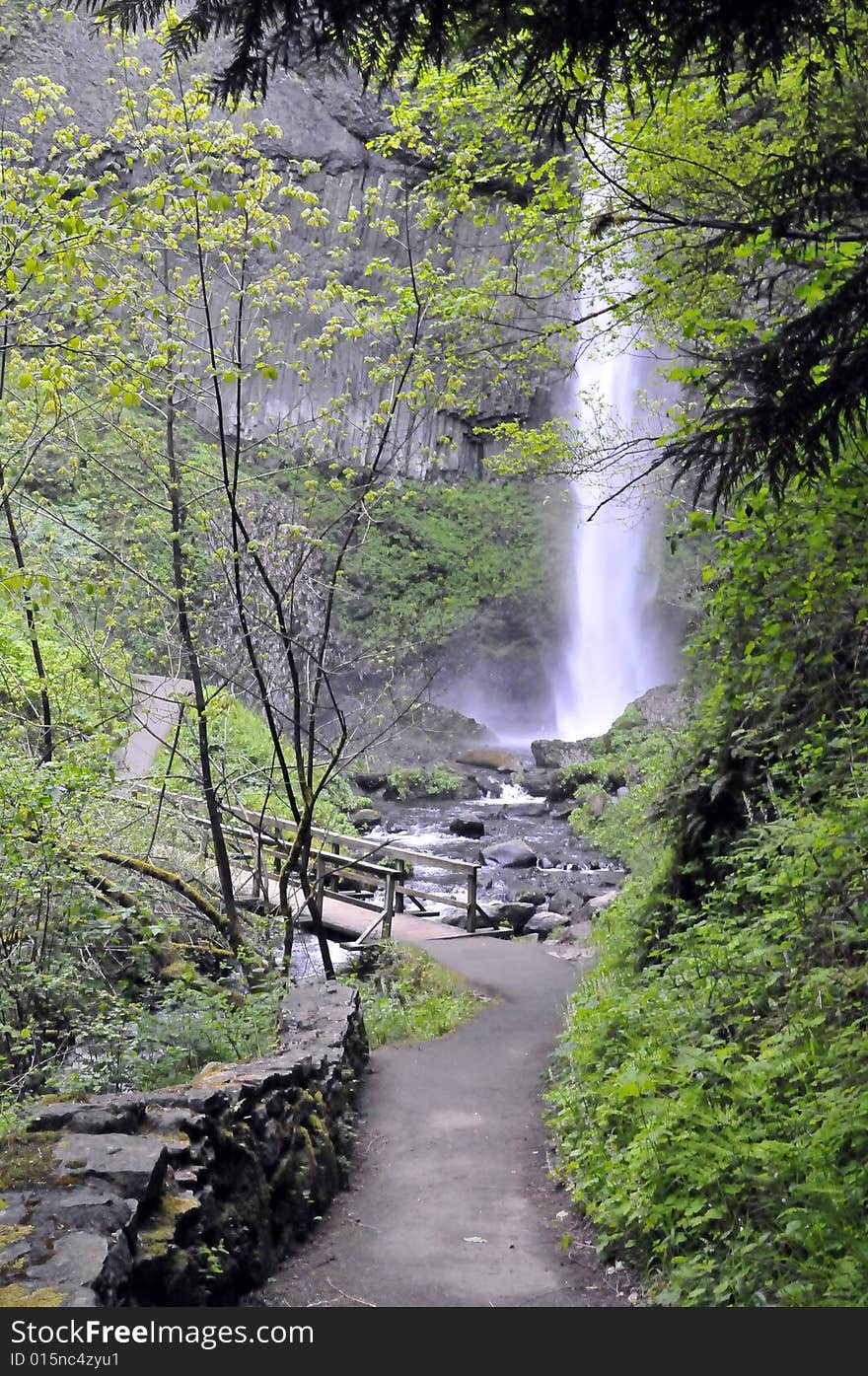 Waterfall behind the bridge over the stream