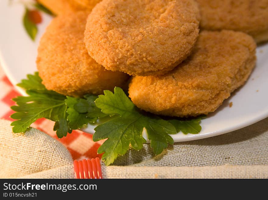 Pieces of chicken empanadas and roasted, on the table, decorated with parsley. Pieces of chicken empanadas and roasted, on the table, decorated with parsley